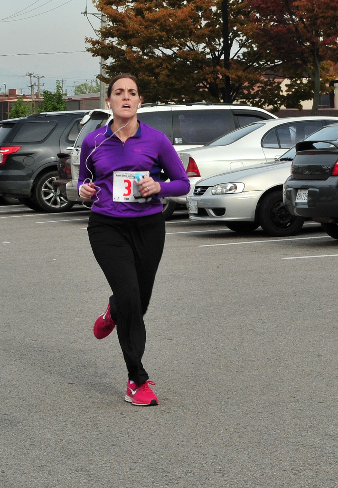 Capt. Nicole Kump, 694th Intelligence, Surveillance and Reconnaissance Group executive officer, approaches the finish line of a Breast Cancer and Domestic Violence Awareness 5K at Osan Air Base, Republic of Korea, Oct. 19, 2013. Kump was the fastest female runner, with a time of 23:07. (U.S. Air Force photo/Airman 1st Class Ashley J. Thum)