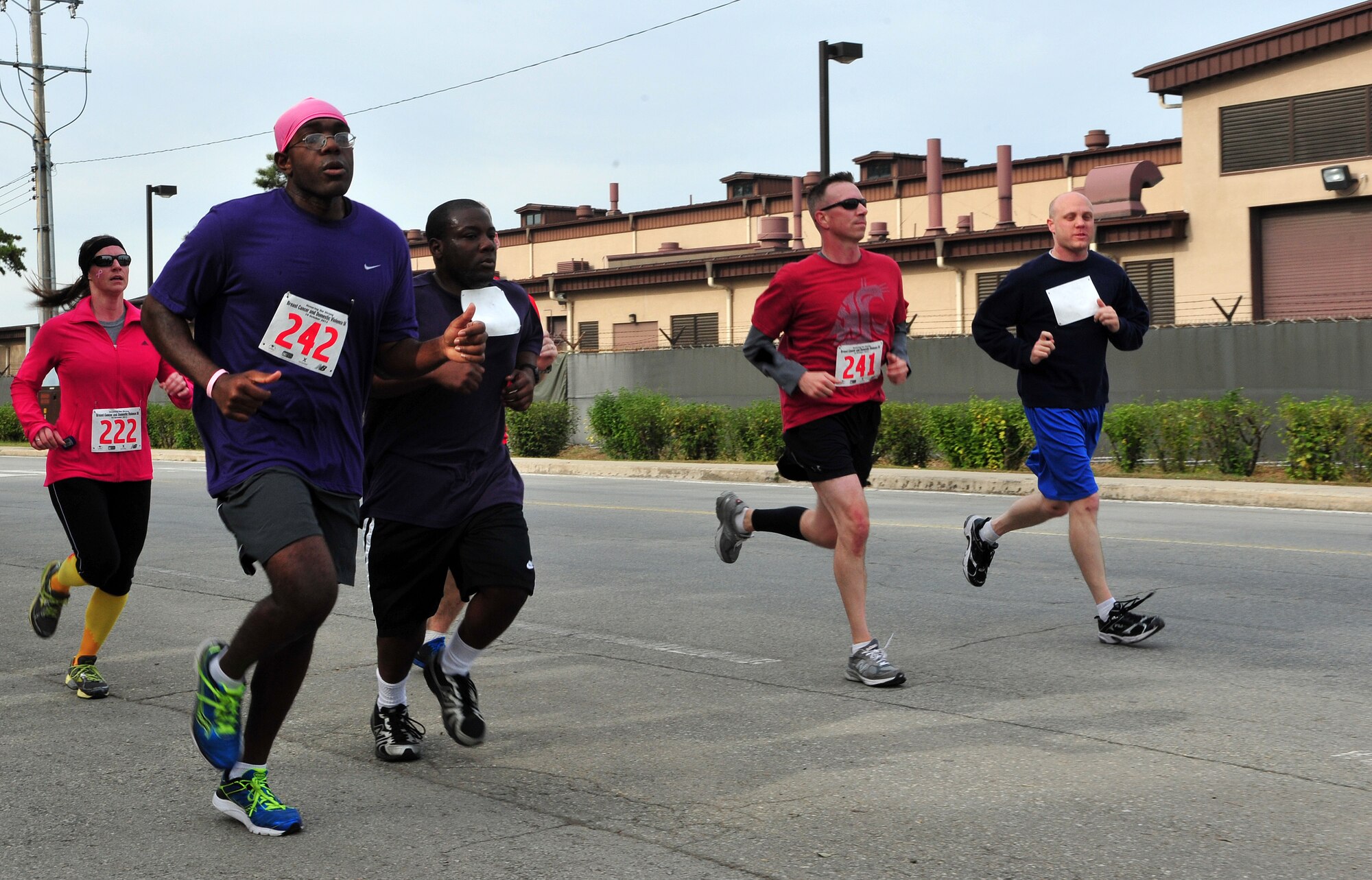 Breast Cancer and Domestic Violence Awareness 5K participants power through the final stretch at Osan Air Base, Republic of Korea, Oct. 19, 2013. Prizes were awarded for the fastest male and female time. (U.S. Air Force photo/Airman 1st Class Ashley J. Thum)