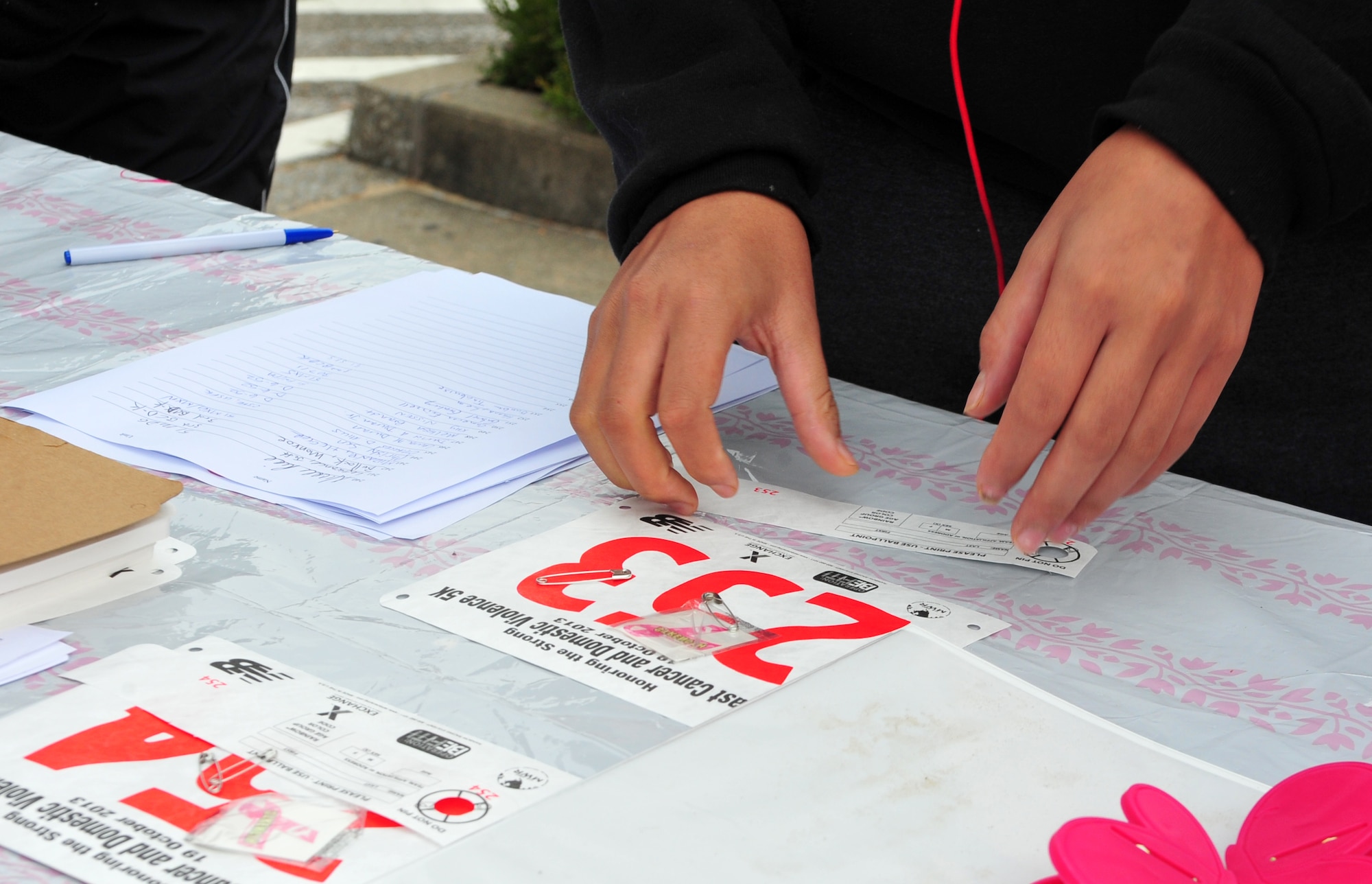 A Breast Cancer and Domestic Violence Awareness 5K runner completes their registration at Osan Air Base, Republic of Korea, Oct. 19, 2013. Approximately 167 runners and walkers participated in the 5K to help promote awareness about finding a cure for breast cancer and speaking out against domestic violence. (U.S. Air Force photo/Airman 1st Class Ashley J. Thum)