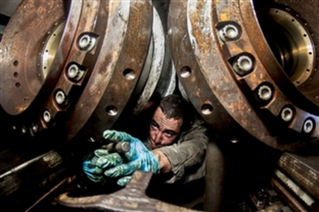 U.S. Navy Airman Tyler Dufford tightens a bolt on a water break aboard the forward-deployed aircraft carrier USS George Washington in the East China Sea, Oct. 18, 2013. The Washington and Carrier Air Wing 5 provide a combat-ready force to protect and defend the maritime interests of the United States and its allies and partners in the Indo-Asia-Pacific region. 