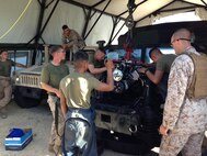 September 12, 2013, Cpl Shoma Nakano prepares a tanker bar to level a 6.5 liter engine in order to correctly align the transmission for reinstallation into a high-mobility multipurpose wheeled vehicle September 12, 2013 in the Central Training Area of Okinawa, Japan. The Marines are working to replace a HMMWV engine during the 3rd Maintenance Battalion Field Exercise 13-2. The exercise provided an opportunity for the Marines to practice their skills in a field environment, better preparing them for real-world operations. Nakano is a Motor Transport Maintenance Technician from 3rd Maintenance Battalion, Combat Logistics Regiment 35, 3rd Marine Logistics Group, III Marine Expeditionary Force.