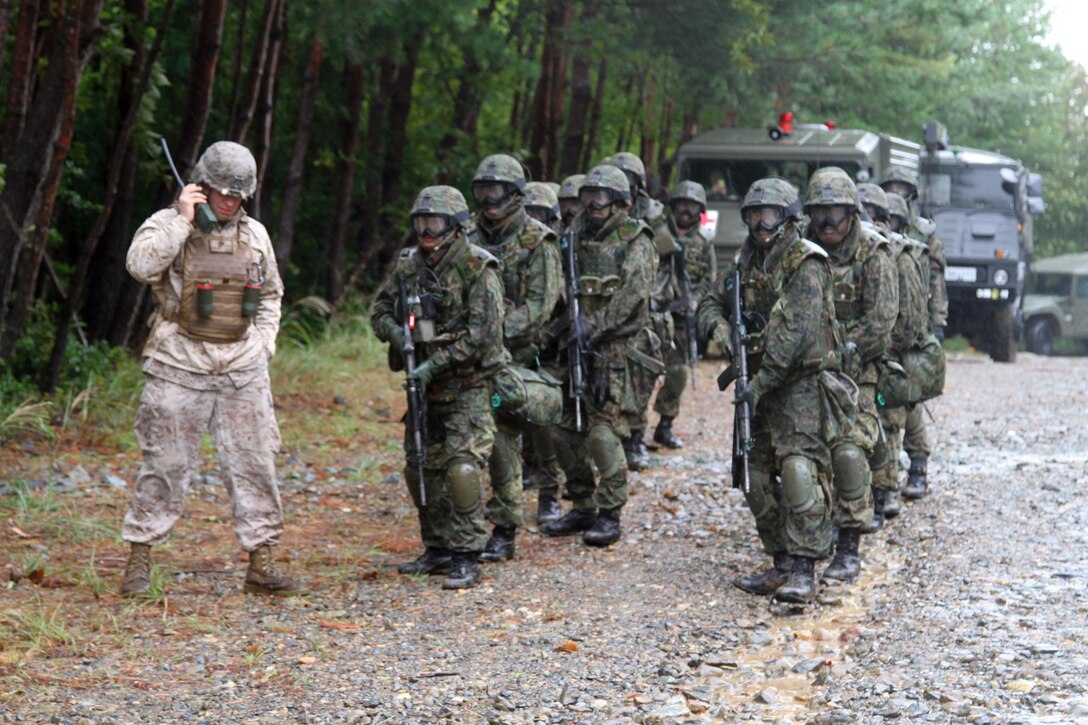 Japanese soldiers wait for the command to embark an MV-22B Osprey for the culmination of the comprehensive exercise during Exercise Forest Light 14-01 Oct. 16 at Aibano Training Area, Shiga prefecture, Japan. Forest Light 14-01 marks the first time the Osprey has been used in training over mainland Japan and the first operation in which members of the Japan Ground Self-Defense Force have worked with the aircraft. The Marines are with Company K, 3rd Battalion, 3rd Marine Regiment, currently assigned to 4th Marine Regiment, 3rd Marine Division, III Marine Expeditionary Unit, under the unit deployment program. The soldiers are with the 37th Infantry Regiment, Central Army of the JGSDF. The Ospreys are assigned to Marine Medium Tiltrotor Squadron 262, 1st Marine Aircraft Wing, III MEF. (U.S. Marine Corps photo by Lance Cpl. Stephen D. Himes/Released)