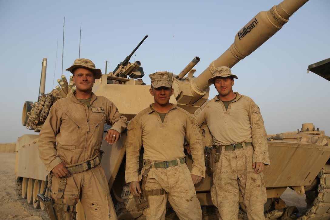 Marines serving with Delta Company, 2nd Tank Battalion, stand in front of their M1A1 Abrams after they conducted a range here, Oct. 10, 2013. The Marines in the tank crew decided to name the tank Mulligan to after they lost their first tank to an improvised explosive device.