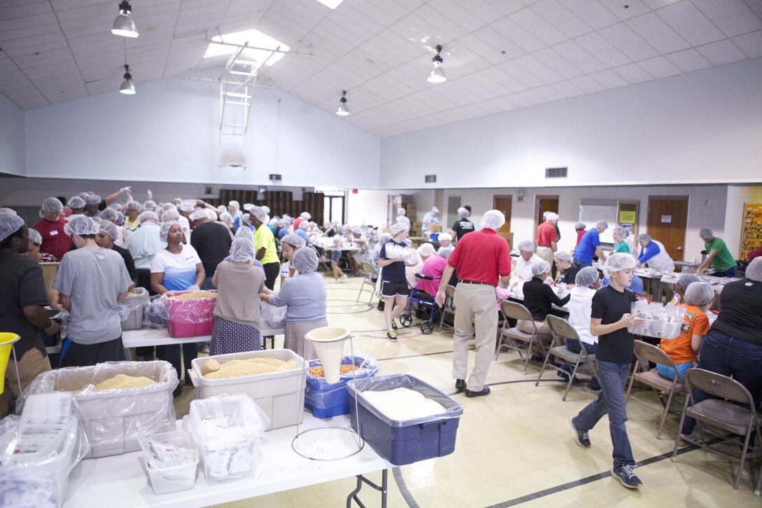 Marines and New Orleans community members pour, seal and box dehydrated meals for crisis relief at the Stop Hunger Now event at Aurora United Methodist Church, Oct. 13. Roughly 150 volunteers from the Marines and the local community attended the church’s event and packaged 50,000 meals. This was the church’s second Stop Hunger Now Event, the first being held in March 2013. (U.S. Marine Corps Photo by Lance Cpl. Tiffany Edwards)
