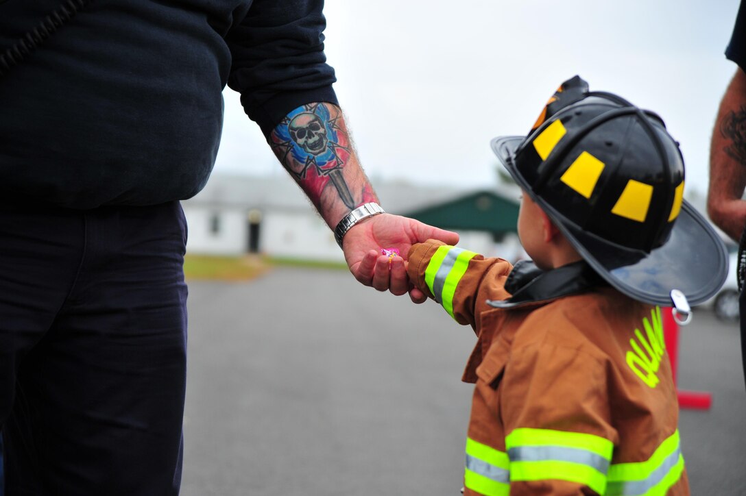 Tommy, 3, takes a piece of candy from a trunk or treater during the 2nd Annual Fall Festival hosted at Weapons Training Battalion on Oct, 19, 2013. The festival gives Marines and their families the chance to meet each other. 