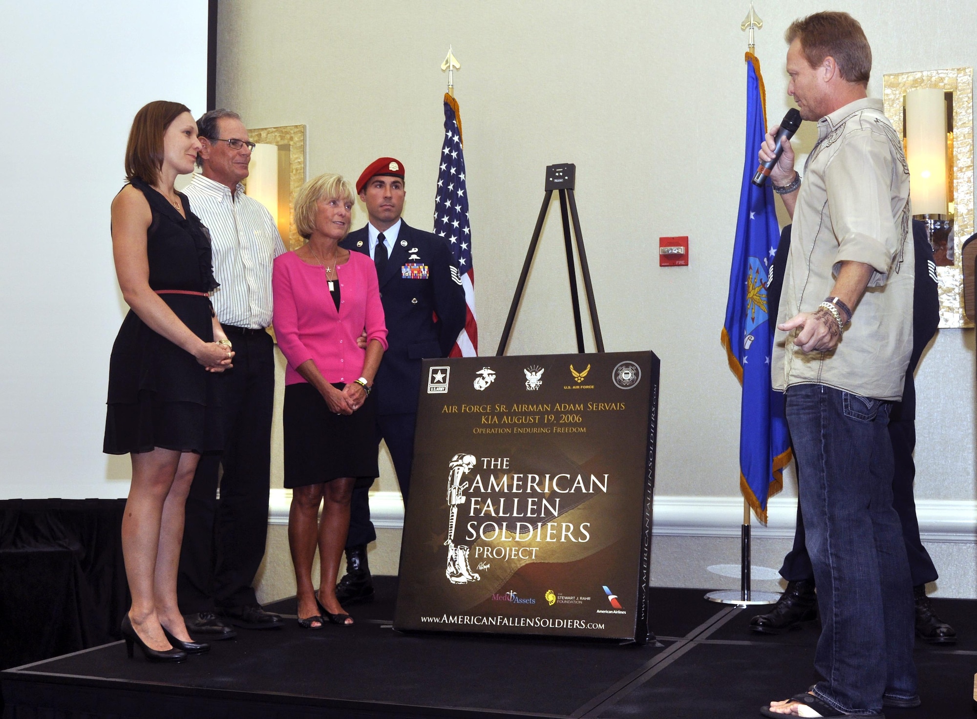 Artist Phil Taylor speaks to the family of Senior Airman Adam Servais before presenting the portrait honoring his service Oct. 19, 2013, in Destin, Fla. Servais was killed in action Aug. 19, 2006, while deployed to Afghanistan as a 23rd Special Tactics Squadron combat controller.