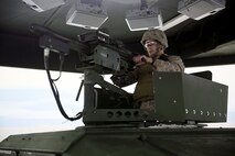 A Marine with 2nd Medical Battalion, Combat Logistics Regiment 25, 2nd Marine Logistics loads a Mk-19 grenade launcher simulator during a virtual convoy at the Lockheed Martin Convoy Combat Simulator aboard Camp Lejeune, N.C., Oct. 18, 2013. Marines were armed with weapons with a wireless connection and checked their sectors of fire while conducting convoy simulations. 