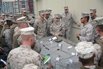 Sgt. Ruben J. Duran (right), a noncommissioned officer with 2nd Medical Battalion, Combat Logistics Regiment 25, 2nd Marine Logistics Group, performs a patrol brief at a sand table outside of the Lockheed Martin Combat Convoy Simulator aboard Camp Lejeune, N.C., Oct. 18, 2013. After receiving a brief, the Marines mounted their Medium Tactical Vehicle Replacement simulator or High Mobility Multipurpose Wheeled Vehicle simulator to execute the mission during a virtual convoy. 