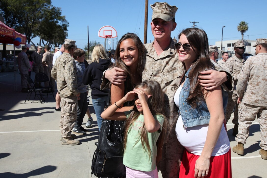 Friends and family of Marines with Supporting Arms Liaison Team 8, 1st Air Naval Gunfire Liaison Company, celebrate the return of their Marines during a homecoming aboard Camp Pendleton, Calif., Oct. 18. The 1st ANGLICO Marines worked directly with the Georgian Armed Forces to provide fire support assistance during combat operations in Afghanistan during their seven-month deployment.