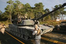 Cpl. Erikon Rosamond (center), a Kosciusko. Miss., native and combat engineer with Bridge Company, 8th Engineer Support Battalion, 2nd Marine Logistics Group, guides an M1A1A1 Abrams Main Battle Tank from 2nd Tank Battalion, 2nd Marine Division onto a raft made up of improved ribbon bridges during a tank crossing aboard Camp Lejeune, N.C., Oct. 17. The tank is just one of many pieces of equipment that can benefit from predictive analysis programs carried out through the Research and Readiness Analysis cell within Marine Corps Systems Command’s Acquisition Logistics and Product Support. 
