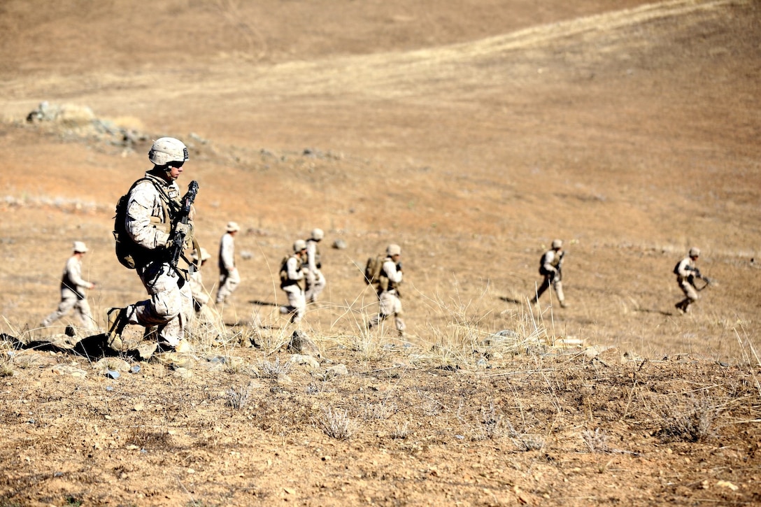 Marines with Lima Company, 3rd Battalion, 5th Marine Regiment, patrol during an integrated exercise on Range 600 here, Oct. 15, 2013. The training helped Marines see how multiple elements of an attack work together to accomplish a single mission. The Marines performed a company-size assault on mock enemy positions preparing them for large-scale offensives they might perform in future operations. The exercise helped the Marines remain ready for any deployment.
