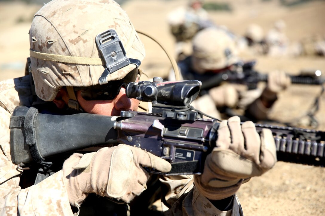 Private First Class Alex Garcia, rifleman, Lima Company, 3rd Battalion, 5th Marine Regiment, and a native of Modesto, Calif., provides security during an integrated exercise on Range 600 here, Oct. 15, 2013. The training helped Marines see how multiple elements of an attack work together to accomplish a single mission. The Marines attacked mock enemy positions while they were supported by artillery fire. The exercise prepared the Marines for future operations.