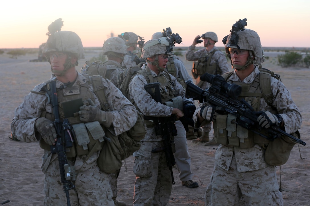 Marines with Bravo Company, 1st Battalion, 7th Marine Regiment, prepare their gear before a high value individual raid exercise here, Oct. 8, 2013. The Bravo Co. Marines inserted during night via CH-53E Super Stallion Helicopters and patrolled to a nearby road where a Marine role playing as a suspected high-ranking insurgent traveled. Once the suspected vehicle arrived, the Marines stopped the travelers, searched and questioned each individual and searched the vehicle for weapons and other forms of intelligence. The battalion is participating in Weapons Training Instructor course before deploying to Afghanistan this spring.