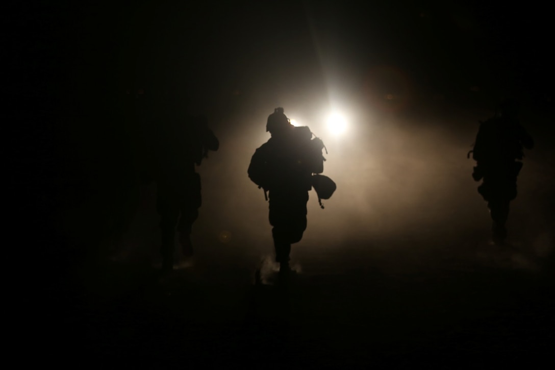 Marines with Bravo Company, 1st Battalion, 7th Marine Regiment, sprint toward a vehicle with suspected insurgents during a high value individual raid exercise here, Oct. 8, 2013. The Bravo Co. Marines inserted during night via CH-53E Super Stallion helicopters and patrolled to a nearby road where a Marine role playing as a suspected high-ranking insurgent traveled. Once the suspected vehicle arrived, the Marines stopped the travelers, searched and questioned each individual and searched the vehicle for weapons and other forms of intelligence.
