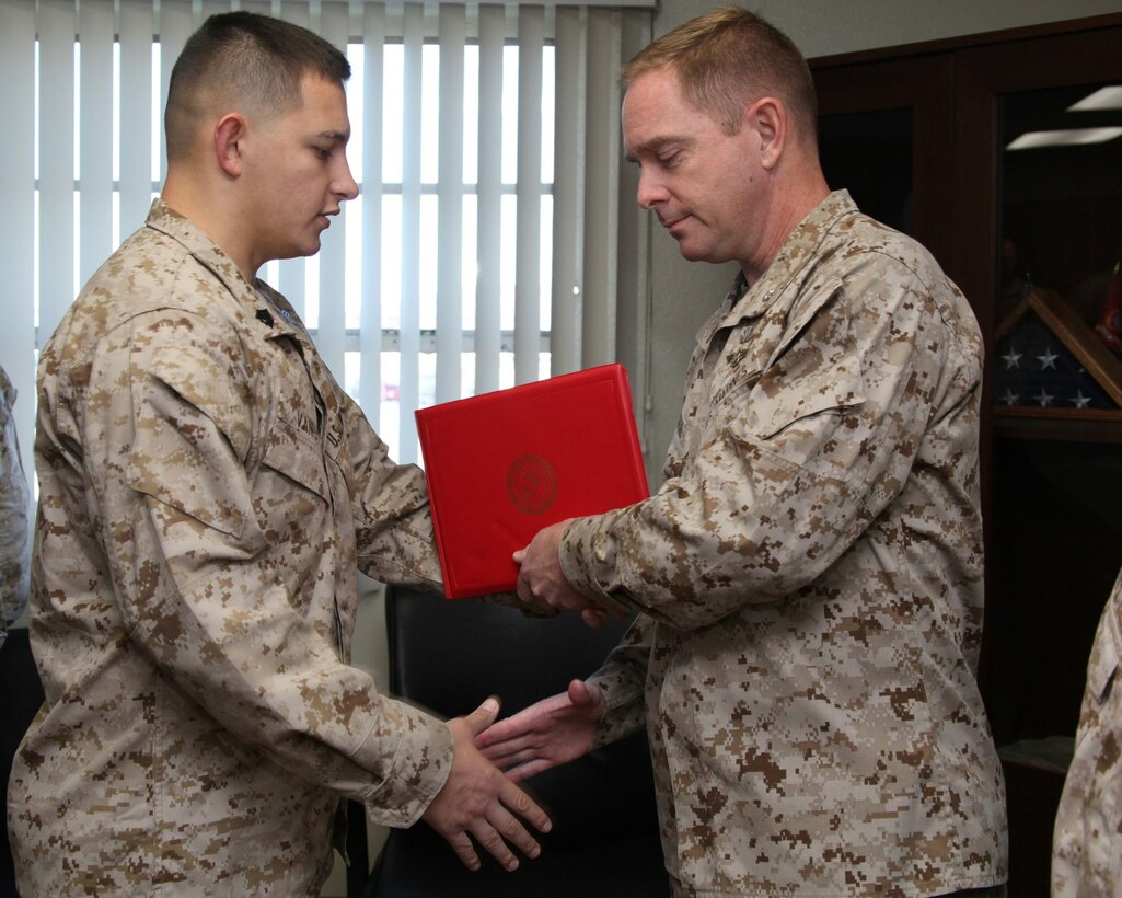 Lieutenant Col. John O'Neal, right, commanding officer, 15th Marine Expeditionary Unit, presents Sgt. Daniel Vance, administrative noncommissioned officer, 15th MEU, with the Navy Marine Corps Achievement Medal aboard Camp Pendleton, Calif., Oct. 16, 2013.  (U.S. Marine Corps photo by Cpl. Jamean R. Berry/Released)