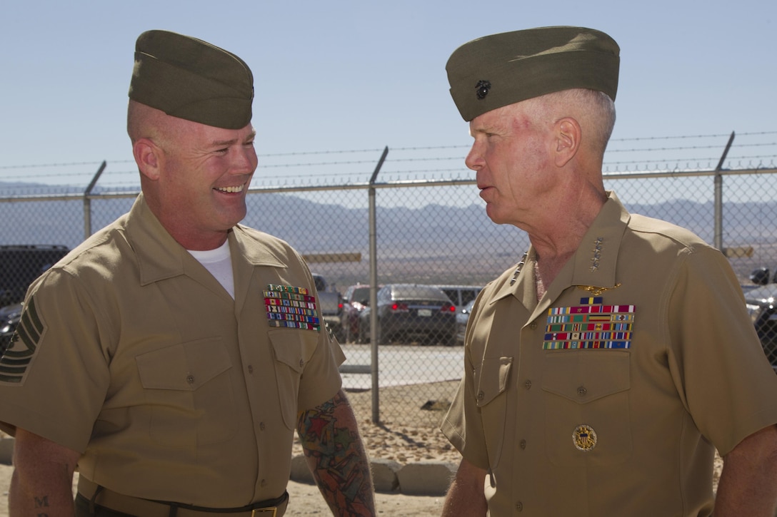 Gen. James F. Amos, Commandant of the Marine Corps, speaks with Master Gunnery Sgt. Douglas P. Fraser, Senior Enlisted Advisor, Marine Corps Tactical Operations Group, during a visit to The Combat Center Oct 17, 2013. Amos and Sgt. Maj. Micheal P. Barrett, Sergeant Major of the Marine Corps, met with leaders from different Combat Center units as a part of a tour addressing the importance of Non-commissioned Officers in the Corps. (USMC photo by Lance Cpl. Rebecca Floto/Released) 
