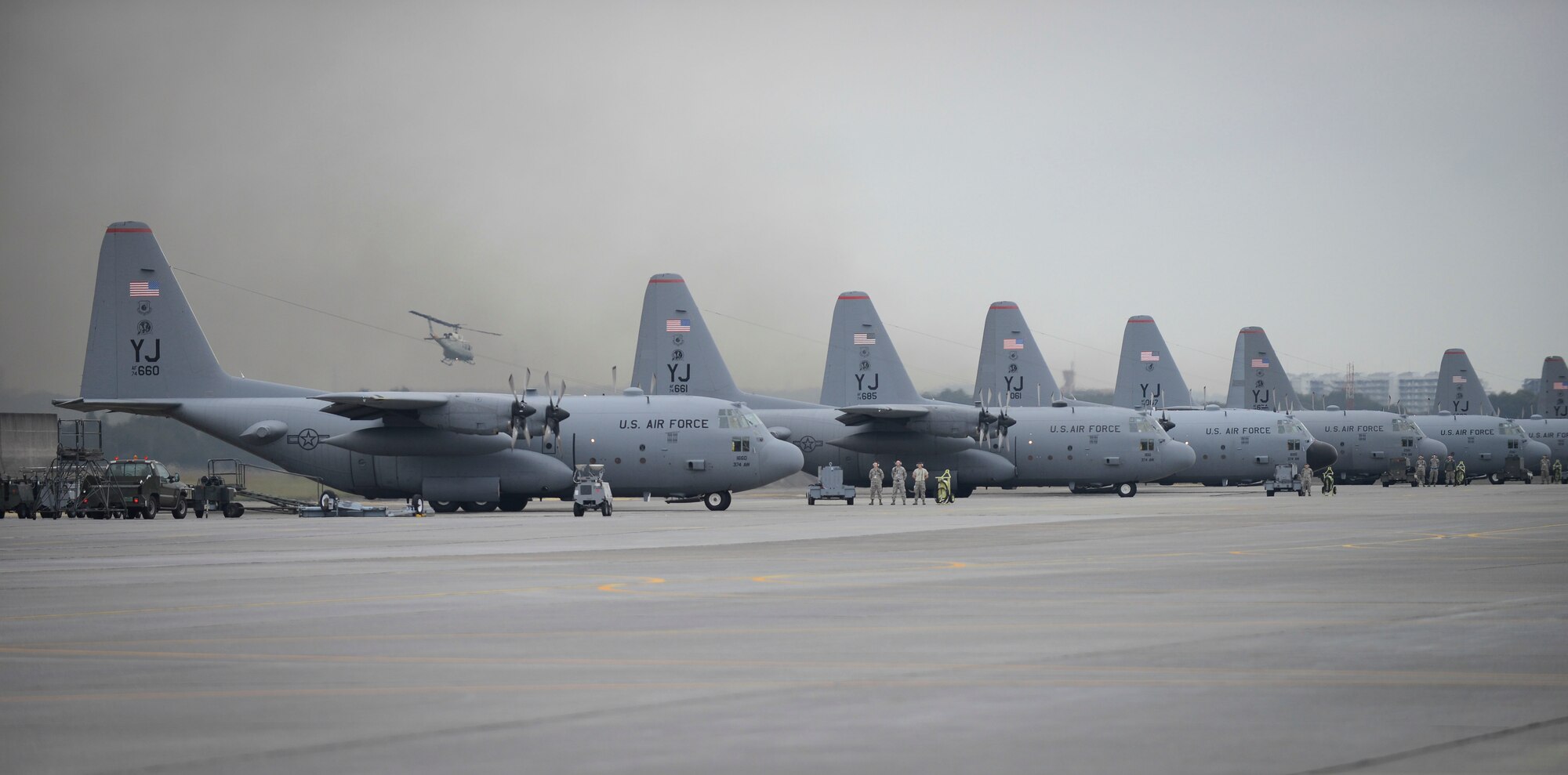 Aircraft wait on the taxiway prior to take off at Yokota Air Base, Japan, Oct. 22, 2013.  The aircraft were flown in a large formation to test Yokota's professional airlift capabilities. (U.S. Air Force photo by Airman 1st Class Meagan Schutter/Released)