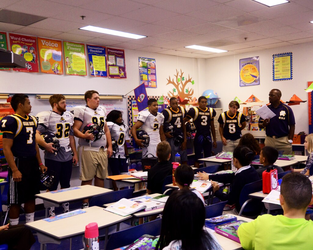 Members of the Guam High School football team lecture a class, Oct. 17, 2013, at Andersen Elementary School, on Andersen Air Force Base, Guam. The team spoke to the class about how to prevent bullying and how to report it. (U.S. Air Force photo by Senior Airman Cierra Presentado/Released)