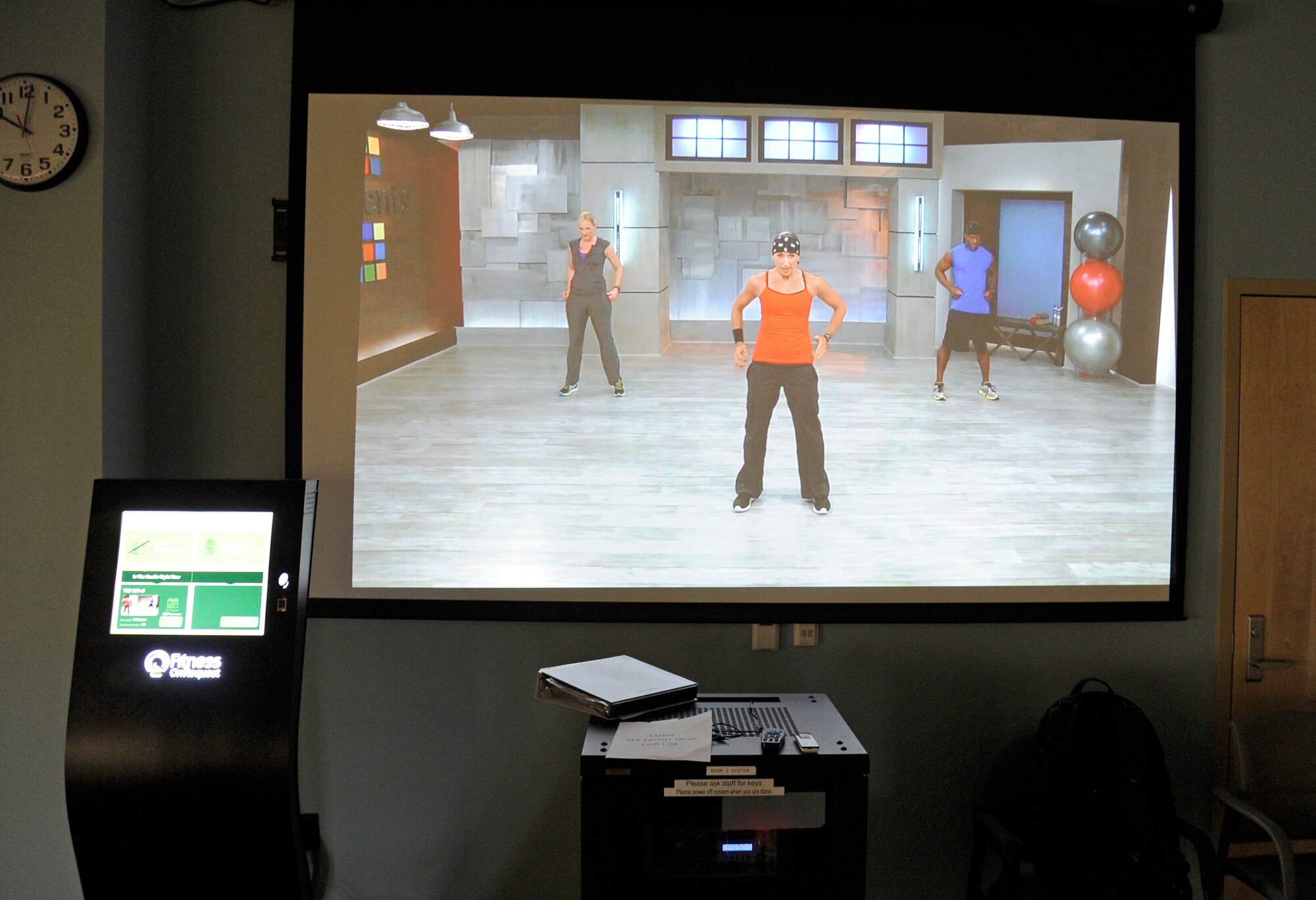 The Fitness On Request system plays one of the group workouts on its projector screen at Fairchild Air Force Base, Wash., Oct. 20, 2013. The purpose is to guide group workouts and ensure everyone has access to a proper workout. (U.S. Air Force photo by Airman 1st Class Ryan Zeski/Released)