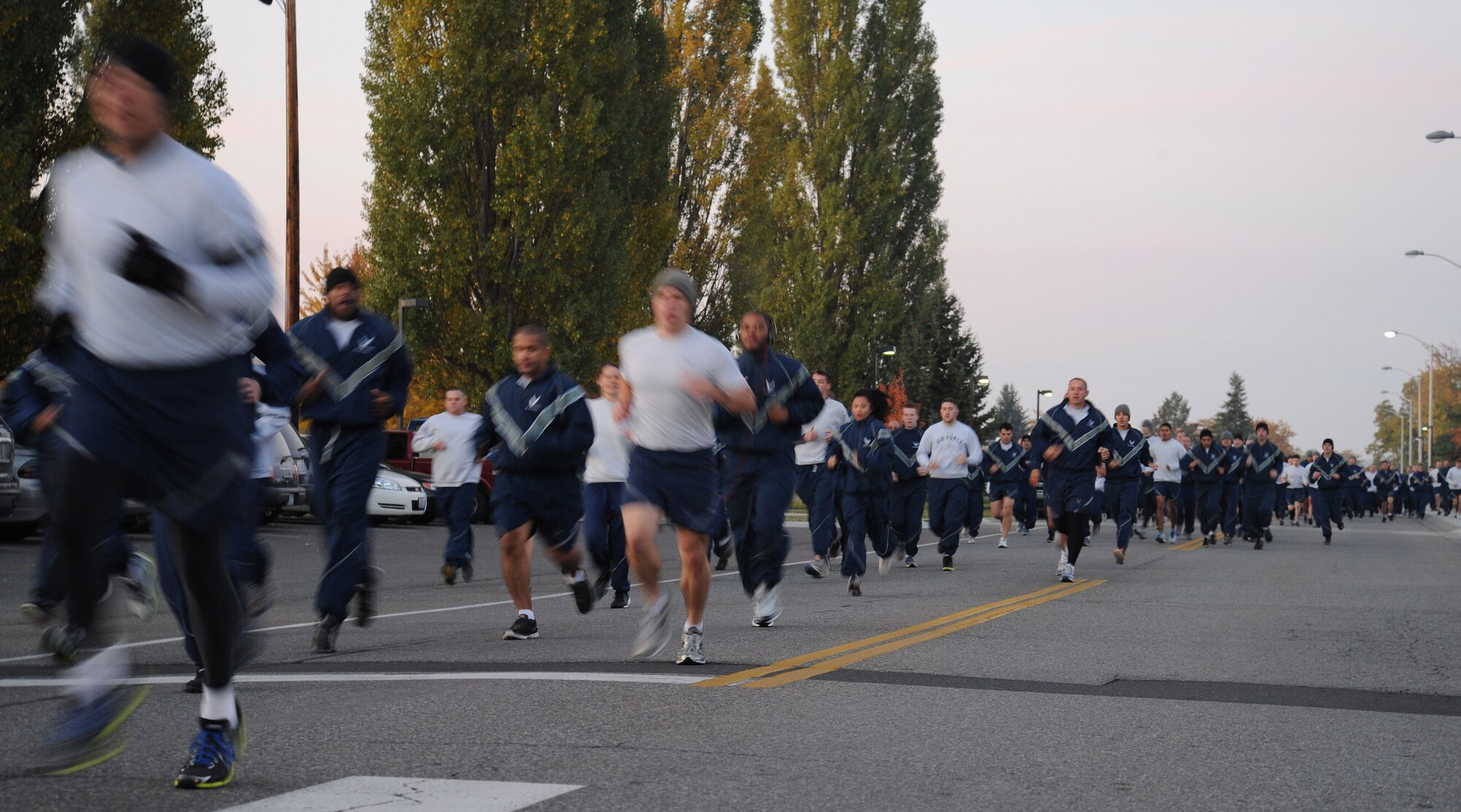 Members of Team Fairchild take off from the starting line during the wing run event at Fairchild Air Force Base, Wash., Oct. 18, 2013. The run covers about 1.5 miles around the base, starting and ending at Miller Park. (U.S. Air Force photo by Airman 1st Class Janelle Patiño/Released)