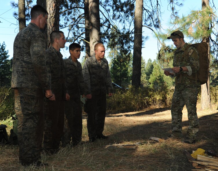 A group of Combat Recue Officer selection candidates are briefed by Senior Airman Russell Batson, 22nd Training Squadron Survival, Evasion, Resistance, Escape specialist, during phase II on how they will be starting a fire at Fairchild Air Force Base, Wash., Oct. 16, 2013. The goal of Phase II is to place the candidates under extreme fatigue and constant stress to see how they think and act under circumstances that are similar to the real world battlefront. (U.S. Air Force photo by Senior Airman Samantha Krolikowski/ Released)