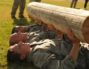 Combat Rescue Officer candidates lift a log during phase two of CRO selection at Fairchild Air Force Base, Wash., Oct. 15, 2013. CROs organize and strategize recovery missions, train and equip rescue personnel, and manage and develop survival skills programs. (U.S. Air Force photo by Senior Airman Samantha Krolikowski/ Released)