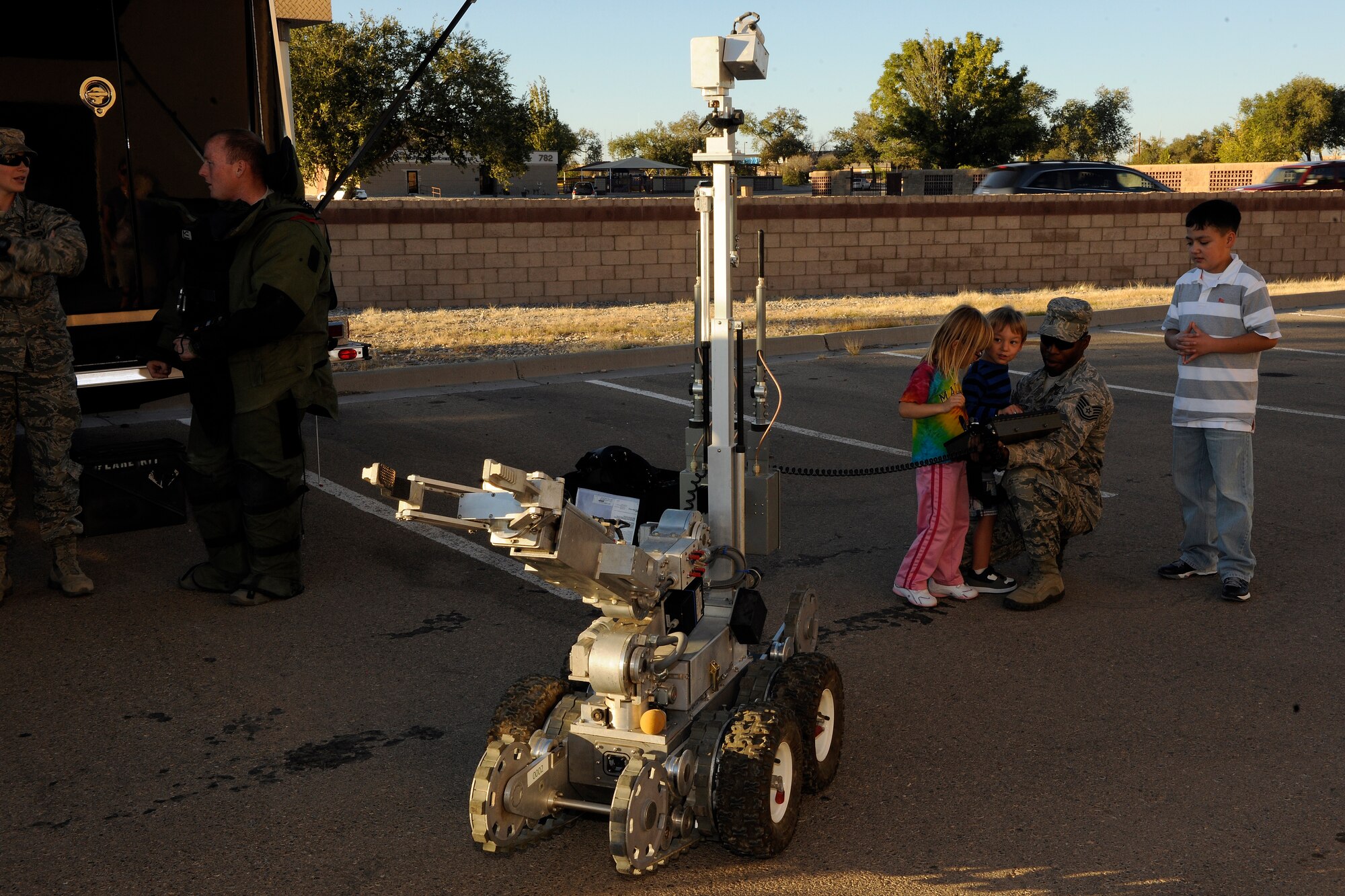 Tech. Sgt. Michael Overton, 49th Civil Engineer Squadron, displays the F-6A Explosive Ordnance Disposal robot during Holloman Middle School's Science Discovery Night at Holloman Air Force Base, N.M., Oct. 18. Students of HMS, as well as various base organizations, displayed projects for all to see. (U.S. Air Force photo by Master Sgt. Kevin P. Milliken/Released)