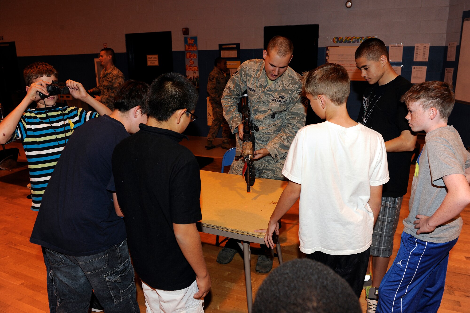 Staff Sgt. Joseph Glover, 49th Security Forces Squadron, displays various tactical devices to students during Holloman Middle School's Science Discovery Night at Holloman Air Force Base, N.M., Oct. 18. Students of HMS, as well as various base organizations, displayed projects for all to see. (U.S. Air Force photo by Master Sgt. Kevin P. Milliken/Released)