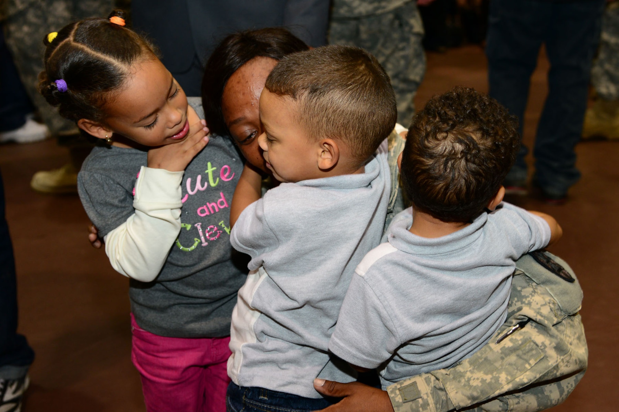 U.S. Army Sgt. Suzie Short, 393rd Harbor Master Detachment, 10th Battalion, 7th Sustainment Brigade supply specialist, greets her children during a redeployment ceremony at the McClellan Fitness Center, Fort Eustis, Va., Oct. 21, 2013. Short was responsible for supporting missions in the surrounding waterways of Kuwait Naval Base, Kuwait, delivering supplies and cargo to Army watercraft. (U.S. Air Force photo by Staff Sgt. Ashley Hawkins/Released)