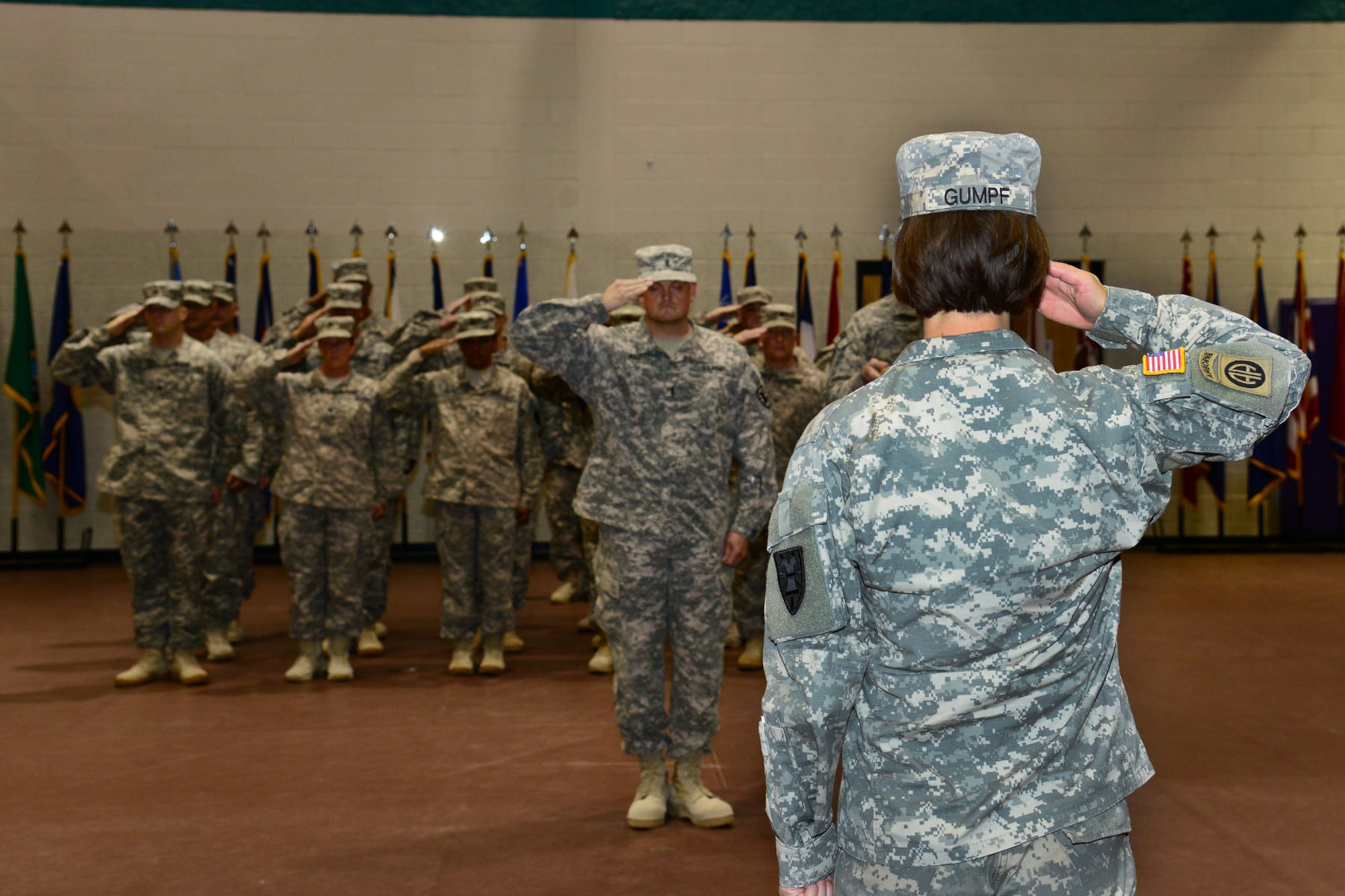 U.S. Army Soldiers from the 393rd Harbor Master Detachment, 10th Battalion, 7th Sustainment Brigade salute Lt. Col. Megan Gumpf, 10th Transportation Battalion commander, as they report back home during a redeployment ceremony at the McClellan Fitness Center, Fort Eustis, Va., Oct. 21, 2013. Approximately 20 Soldiers returned home from a nine-month deployment to Kuwait Naval Base, Kuwait. (U.S. Air Force photo by Staff Sgt. Ashley Hawkins/Released)