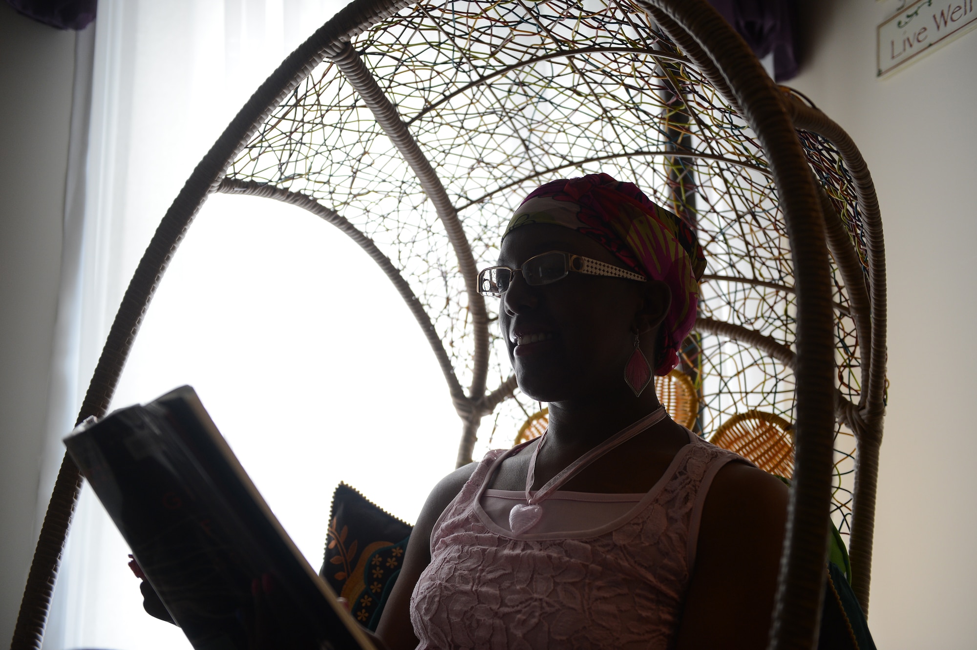 Retired Senior Master Sgt. Ronshella White sits and reads a book in her home as she enjoys retirement, Oct. 15, 2013, Sumter, S.C. White is an avid supporter of seeking knowledge and education and enjoys reading. She holds four associate degrees from the Community College of the Air Force, a bachelor’s degree in resource management, a Bachelor of Science and Education, a master’s degree in business administration, and she’s currently pursuing a doctoral degree in management. (U.S. Air Force photo by Airman 1st Class Daniel Blackwell/Released)
