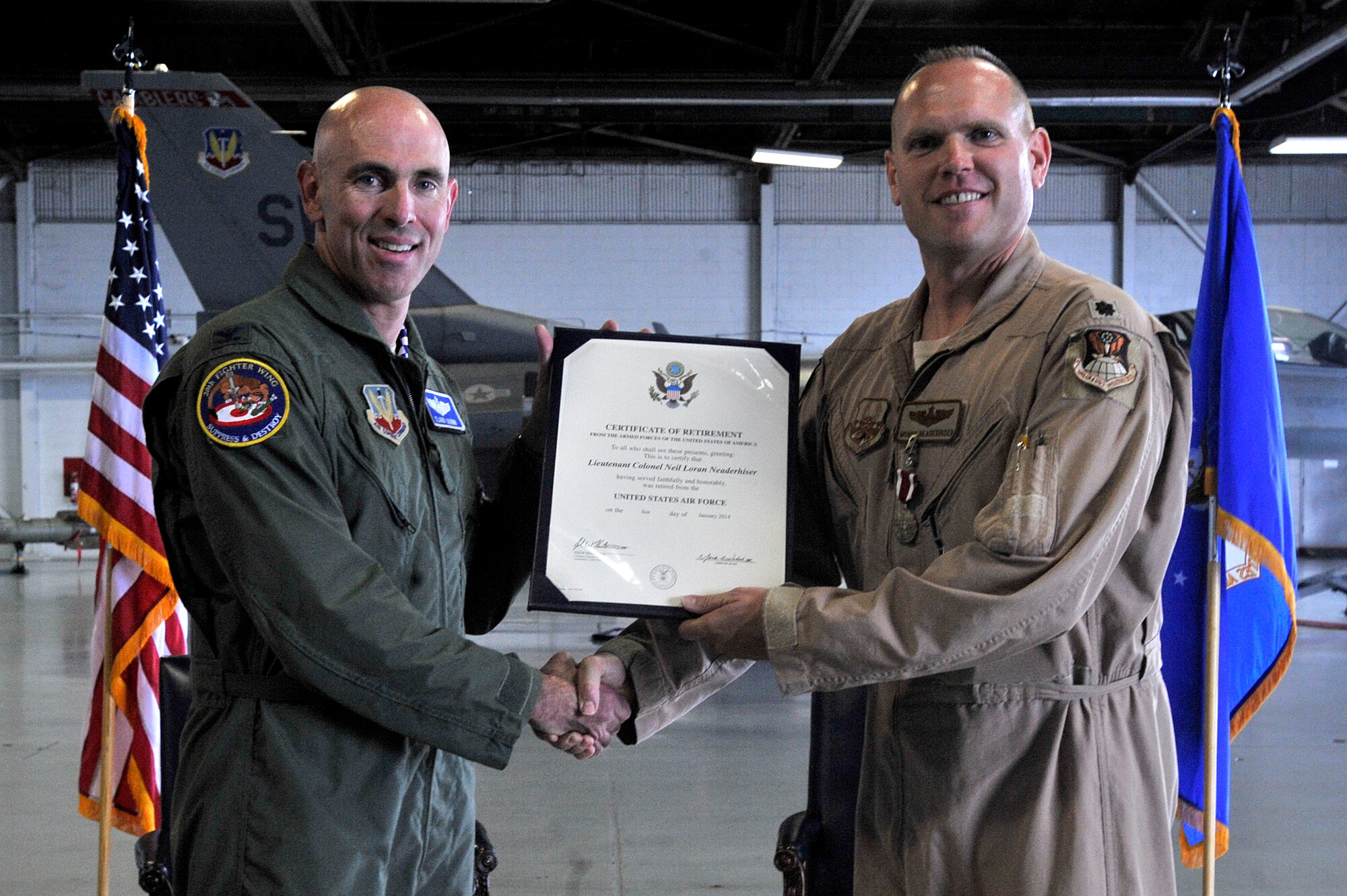 U.S. Air Force Col. Clark Quinn, 20th Fighter Wing vice commander, presents Lt. Col. Neaderhiser, 609th Air and Space Operations Center Chief of Contingency Operations, his retirement certificate during Neaderhiser’s retirement ceremony at Shaw Air Force Base, S.C., Oct. 18, 2013.  Neaderhiser gathered with family, friends and fellow Airmen to celebrate his 21-year career in the Air Force.  (U.S. Air Force photo by Airman 1st Class Jensen Stidham/Released)