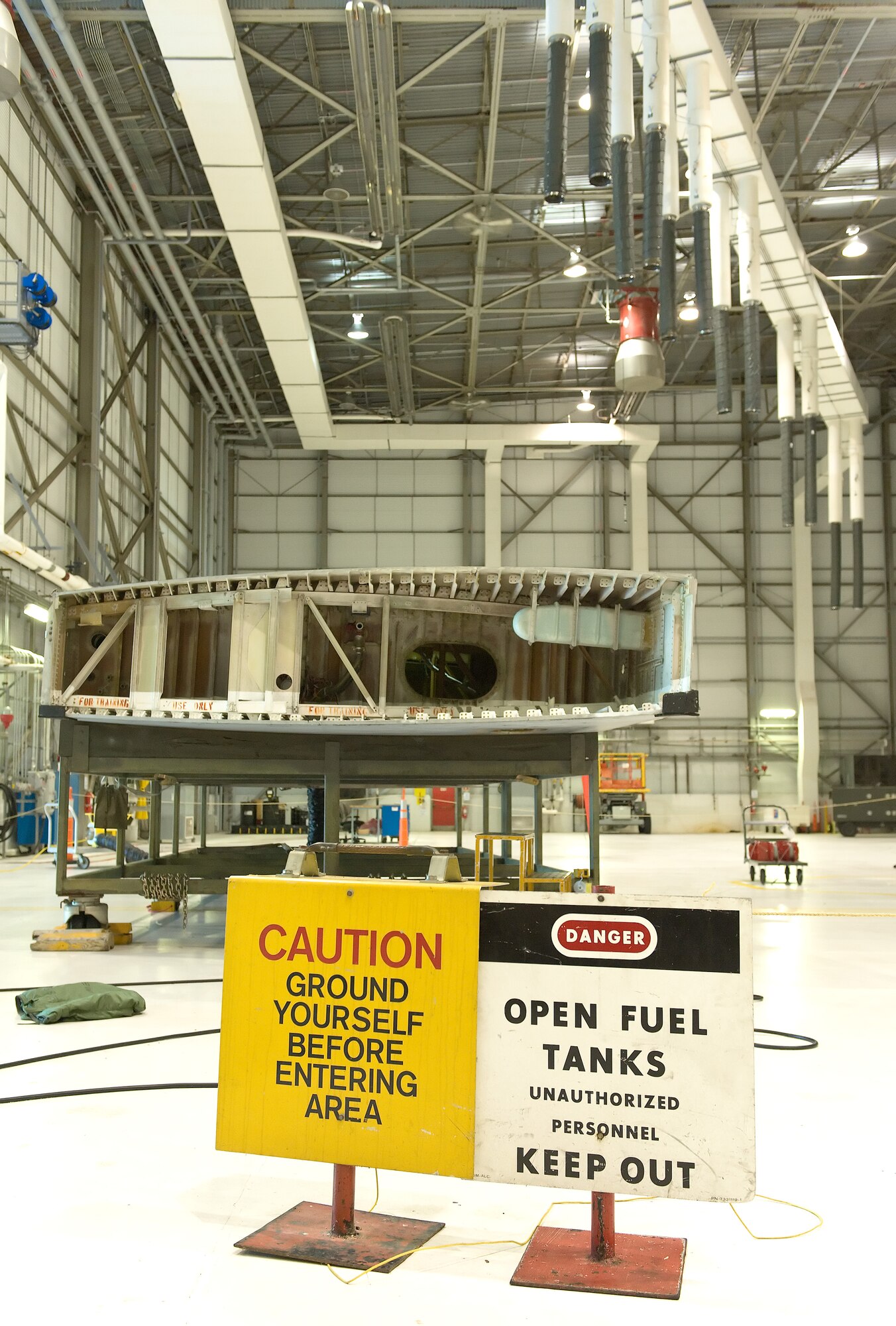 A C-5A auxiliary fuel tank sits in the Aircraft Fuel Systems Repair Facility Oct. 18, 2013, at Dover Air Force Base, Del. The fuel tank serves as a trainer for aircraft fuel system maintainers and first responders during annual confined space rescue training exercises. (U.S. Air Force photo/Roland Balik)
