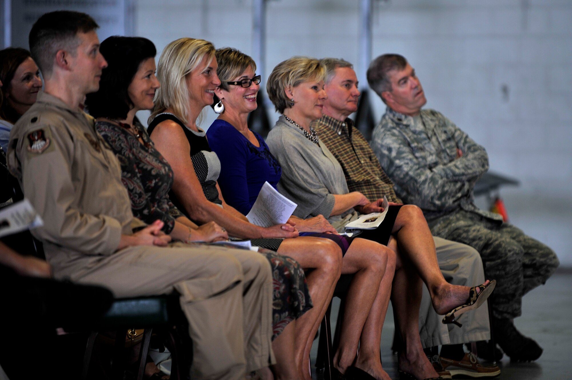 Family, friends and fellow Airmen sit, listen and laugh during Lt. Col. Neil Neaderhiser’s, 609th Air and Space Operations Center Chief of Contingency Operations, retirement ceremony at Shaw Air Force Base, S.C., Oct. 18, 2013.  Neaderhiser, at times, used humor to describe his 21-year career in the Air Force. (U.S. Air Force photo by Airman 1st Class Jensen Stidham/Released)