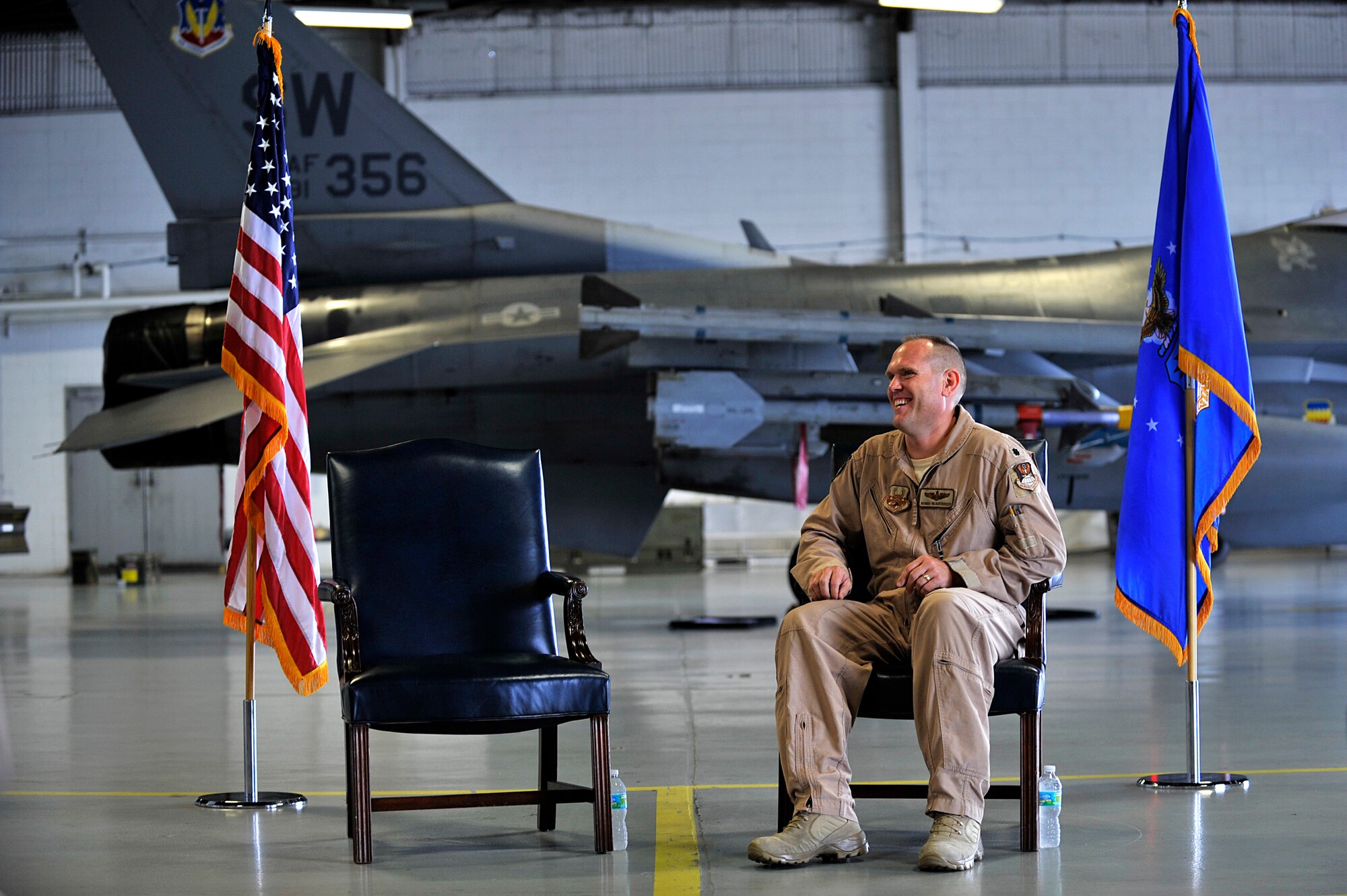 U.S. Air Force Lt. Col. Neil Neaderhiser, 609th Air and Space Operations Center Chief of Contingency Operations, sits and laughs during his retirement ceremony at Shaw Air Force Base, S.C., Oct. 18, 2013.  Neaderhiser gathered with family, friends and fellow Airmen to celebrate his 21-year career in the Air Force. (U.S. Air Force photo by Airman 1st Class Jensen Stidham/Released)