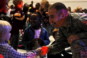 U.S. Air Force 2nd Lt. Justin Lewis, U.S. Air Force Heritage of America Band flight commander, speaks with students after a concert at Armstrong Elementary School in Hampton, Va., Oct. 18, 2013. The band’s rock ensemble, “Full Spectrum,” performed for approximately 320 students at a concert that was the culmination of a cultural exchange initiative that began April 2013. (U.S. Air Force photo by Airman 1st Class R. Alex Durbin/Released)