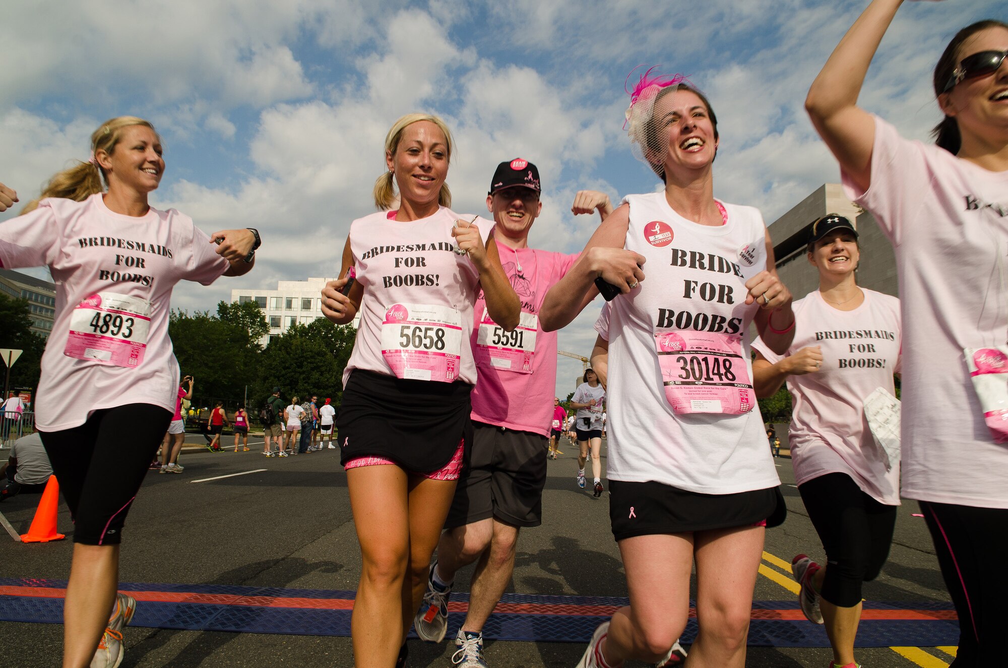 Capt. Candice Adams Ismirle and her bridesmaids cross the finish line of the Susan G. Komen Race for the Cure June 6, 2012, in Washington, D.C. Ismirle and friends completed the 5K race on the morning of her wedding. (U.S. Air Force photo by Staff Sgt. Russ Scalf)