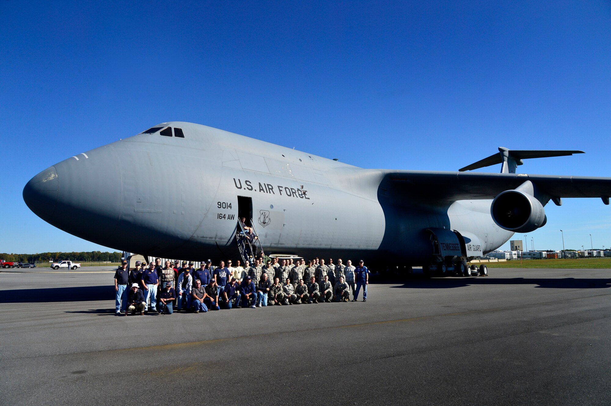 Volunteers from the Air Mobility Command Museum and members of the 436th Maintenance Group qualification training program pose in front of the new C-5A Galaxy Oct. 21, 2013, at the Air Mobility Command Museum on Dover Air Force Base, Del.  The volunteers along with students and instructors from the qualification training program had just finished positioning the C-5A Galaxy into its new spot at the museum. (U.S. Air Force photo/David Tucker)