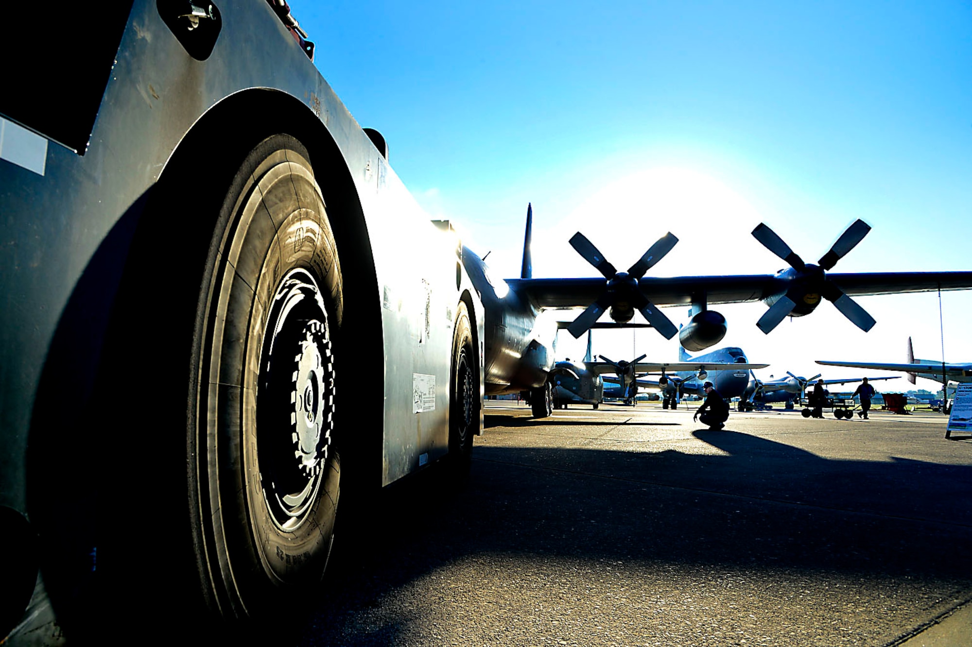 A museum volunteer crouches under the wing of an aircraft while it is being towed to a new position Oct. 21, 2013, at the Air Mobility Command Museum on Dover Air Force Base, Del. The planes were being moved to make room for a new C-5A Galaxy which will be unveiled in a ceremony Nov. 9. (U.S. Air Force photo/David Tucker)