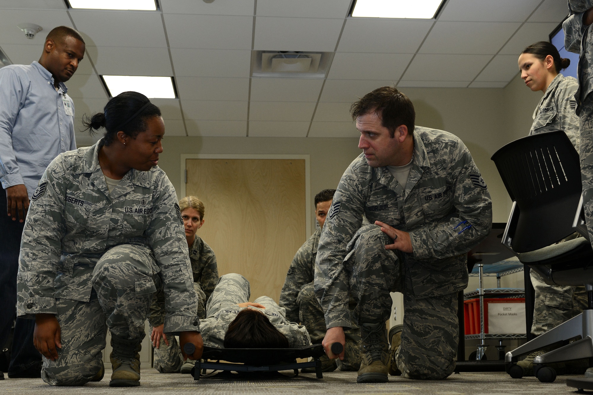 U.S. Air Force Airmen learn the proper way to perform a litter carry during the 633rd Medical Group Education and Training Center’s Self-Aid and Buddy Care class at Langley Air Force Base, Va., Oct. 18, 2013. After initial SABC training, Airmen are required to complete annual or pre-deployment training. (U.S. Air Force photo by Airman 1st Class Kimberly/Released)