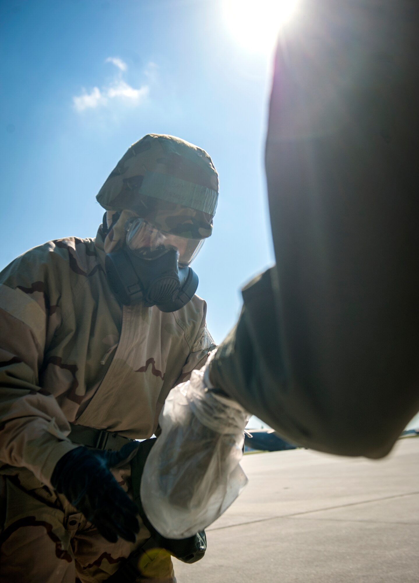 U.S. Air Force Tech. Sgt. Andrew Medford, 347th Operations Support Squadron aircrew flight equipment (AFE) technician, takes overboots off a wingman as he enters an aircraft at Moody Air Force Base, Ga., Oct. 17, 2013. AFE cautions that while wearing overboots, it’s important that Airmen don’t drag their feet, because the plastic can create static electricity. (U.S. Air Force photo by Senior Airman Jarrod Grammel/Released)
