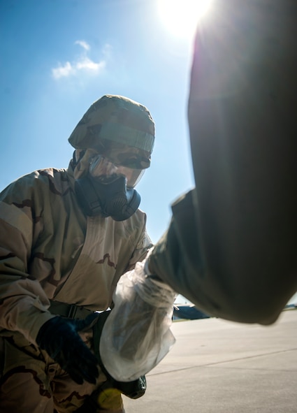 U.S. Air Force Tech. Sgt. Andrew Medford, 347th Operations Support Squadron aircrew flight equipment (AFE) technician, takes overboots off a wingman as he enters an aircraft at Moody Air Force Base, Ga., Oct. 17, 2013. AFE cautions that while wearing overboots, it’s important that Airmen don’t drag their feet, because the plastic can create static electricity. (U.S. Air Force photo by Senior Airman Jarrod Grammel/Released)
