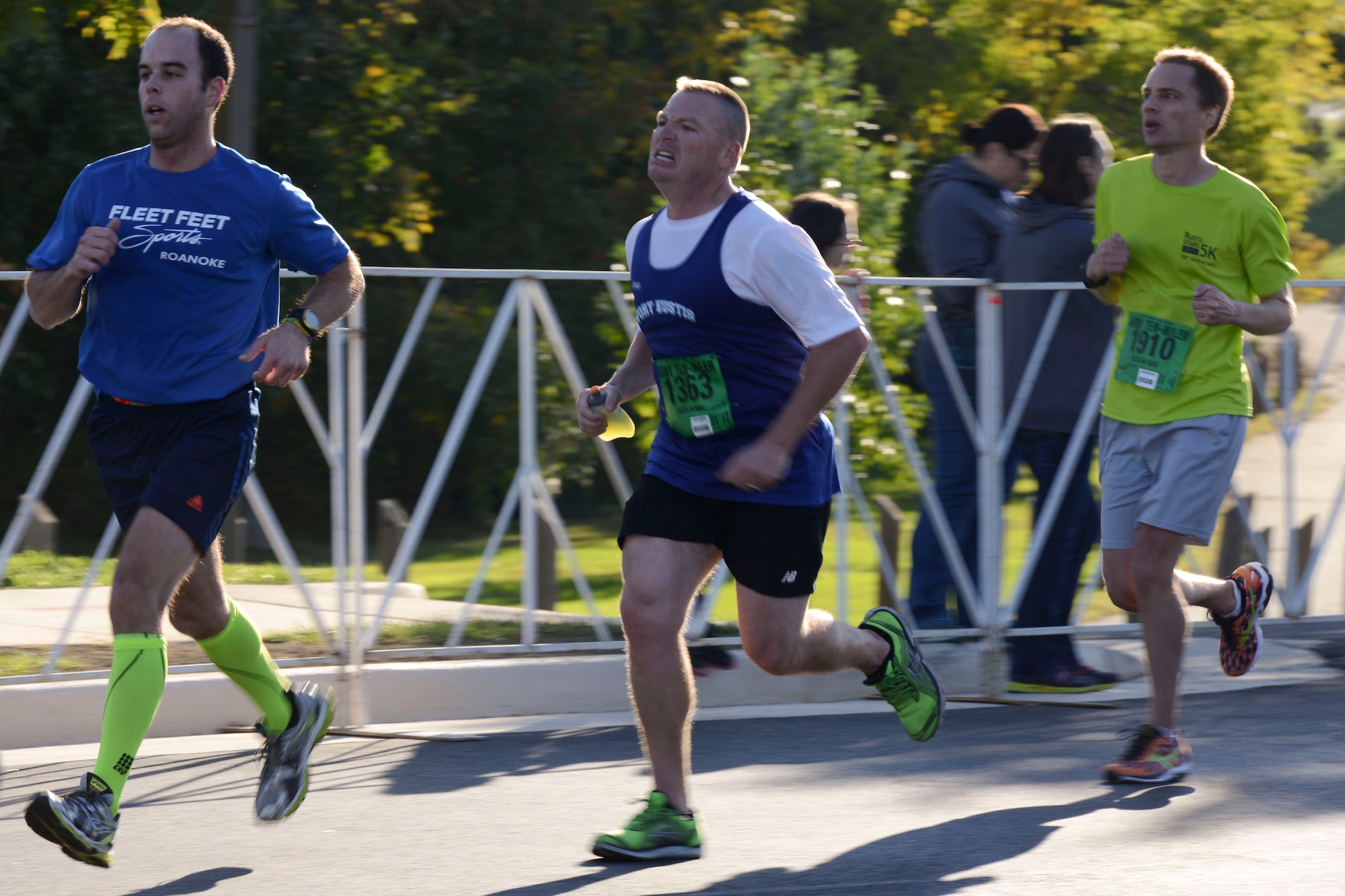 U.S. Army Sgt. 1st Class William Littell, center, Fort Eustis Ten-Mile team member, approaches the finish line during the U.S. Army Ten-Miler race in Washington, D.C., Oct. 20, 2013. Marathons, distance running and the Ironman Triathlon were all part of the Fort Eustis team’s preparation for the ATM (U.S. Air Force photo by Staff Sgt. Ciara Wymbs/Released)