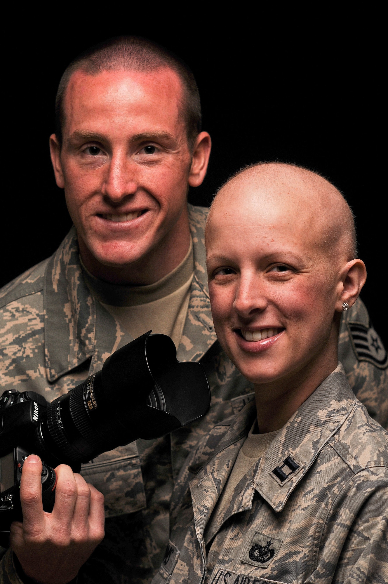 Staff Sgt. Russ Scalf and Capt. Candice Adams Ismirle pose for a studio photo April 8, 2011, at Fort George G. Meade, Md. (U.S. Air Force photo by Master Sgt. Justin Pyle)