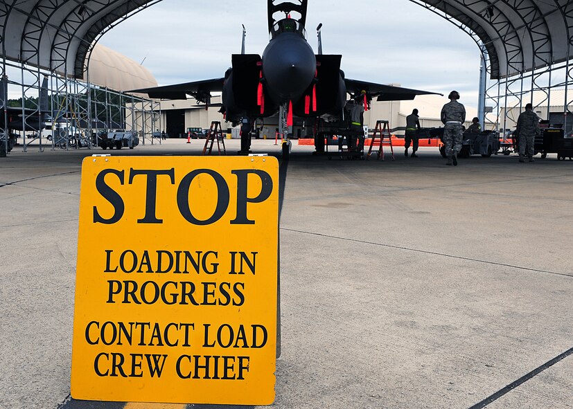 U.S. Air Force Airmen assigned to the 4th Aircraft Maintenance Squadron participate in a load crew of the quarter competition at Seymour Johnson Air Force Base, N.C., Oct. 18, 2013. Airmen represented their respective units in a race against each other to determine who could perform munitions loading operations the fastest with the most accuracy. (U.S. Air Force photo by Airman 1st Class John Nieves Camacho)