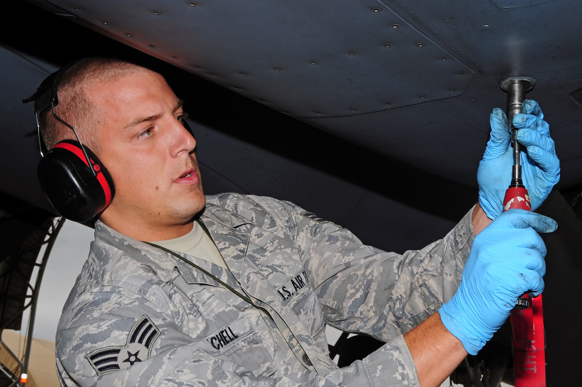 U.S. Air Force Senior Airman Jeffrey Mitchell, 4th Aircraft Maintenance Squadron avionics technician, works on an F-15E Strike Eagle aircraft during a load crew competition at Seymour Johnson Air Force Base, N.C., Oct. 18, 2013. Competitors were evaluated on their efficiency and safety while loading munitions and pods. (U.S. Air Force photo by Airman 1st Class John Nieves Camacho)