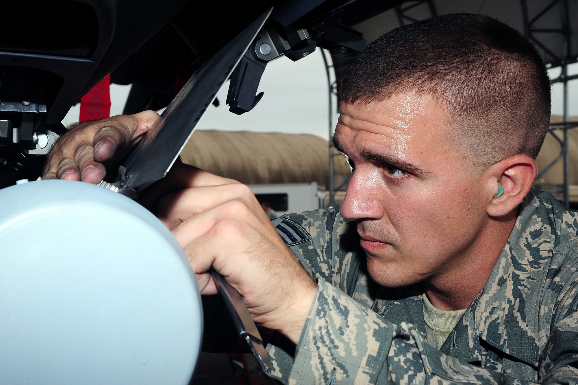 U.S. Air Force Senior Airman Jonathan Byerly, 4th Aircraft Maintenance Squadron load crew member, installs a fin on a practice bomb during a load crew competition at Seymour Johnson Air Force Base, N.C., Oct. 18, 2013. Airmen worked with keen attention to detail to ensure procedures were done correctly to earn maximum points during the event. (U.S. Air Force photo by Airman 1st Class John Nieves Camacho)