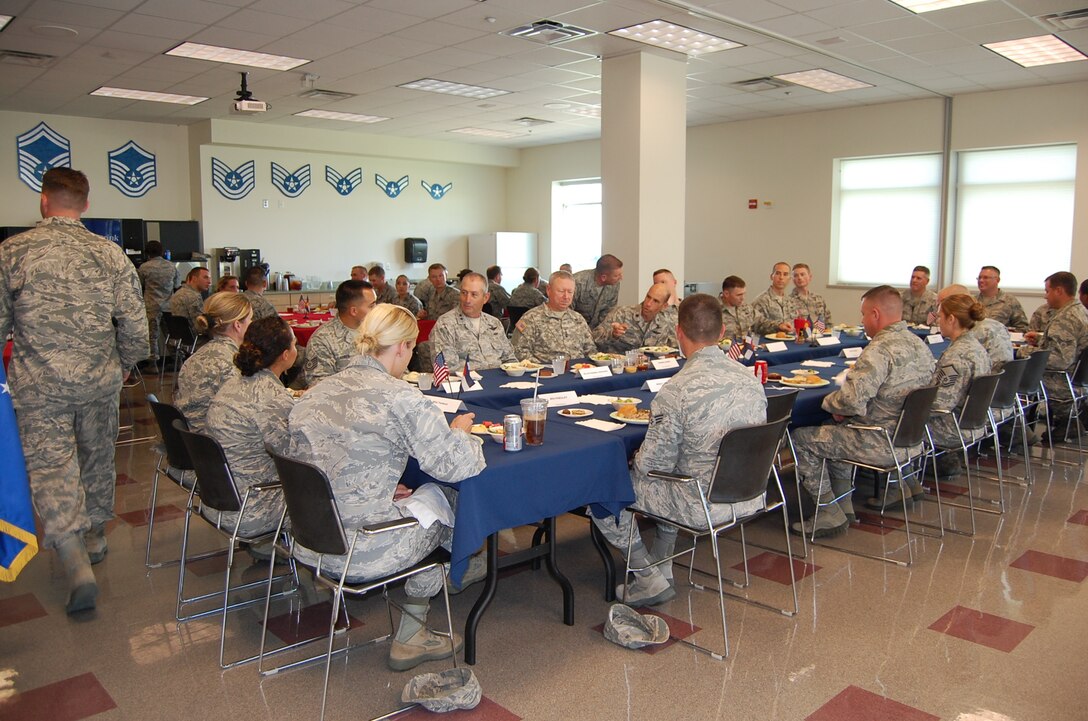Gen. Frank Grass, chief, National Guard Bureau, and Maj. Gen. H. Michael Edwards, adjutant general, Colorado National Guard, share a meal with members of the 233d Space Group in Greeley, Colo. during their site visit Sept. 14. (Air National Guard photo by Capt. Kinder Blacke)