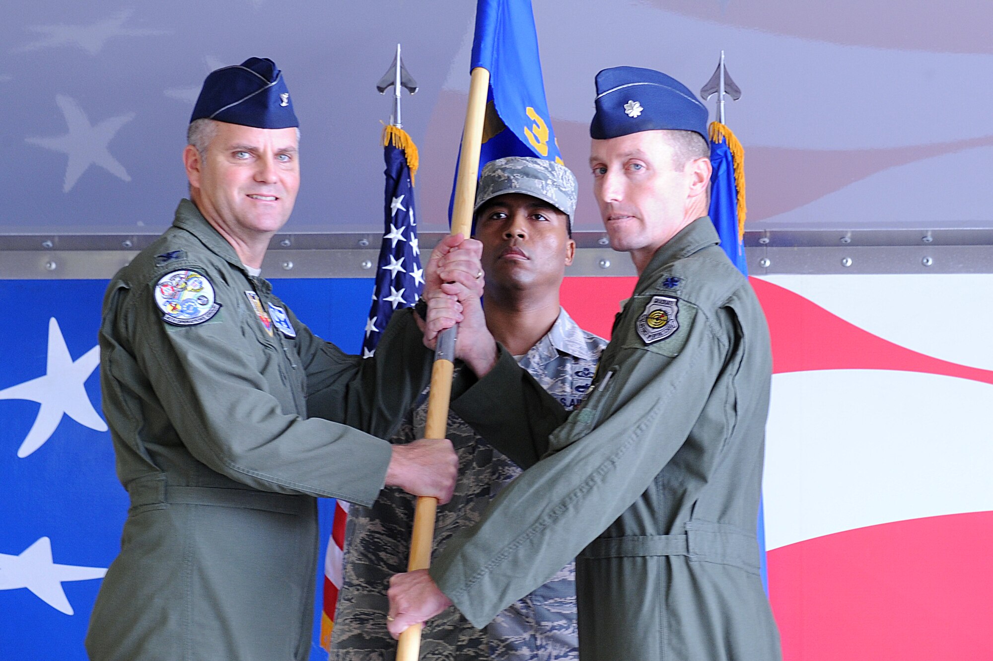 U.S. Air Force Lt. Col. James Howard, 336th Fighter Squadron outgoing commander, hands the squadron guidon to Col. Michael Koscheski, 4th Operations Group commander, during a change of command ceremony at Seymour Johnson Air Force Base, N.C., Oct. 18, 2013.  The 336th FS has been flying the F-15E Strike Eagle since the aircraft’s induction into the Air Force’s arsenal in 1988.  (U.S. Air Force photo by Airman 1st Class Aaron Jenne)