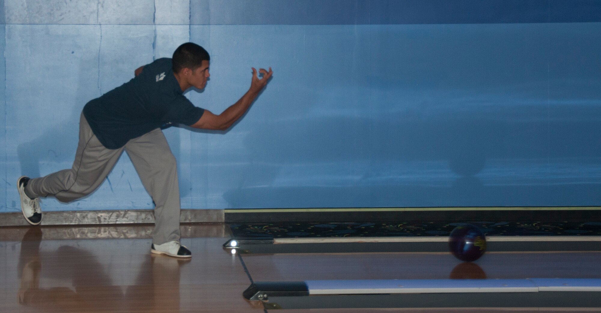 131017-F-GZ967-025 2nd Lt. Justin Smith, 90th Comptroller Squadron, sends the bowling ball down lane during the “Strike Out Domestic Violence” bowling tournament Oct. 17, 2013. Smith was one of 60 Airmen who volunteered their time to participate in the event  designed to increase awareness of domestic violence. (U.S. Air Force photo by Airman 1st Class Brandon Valle) 